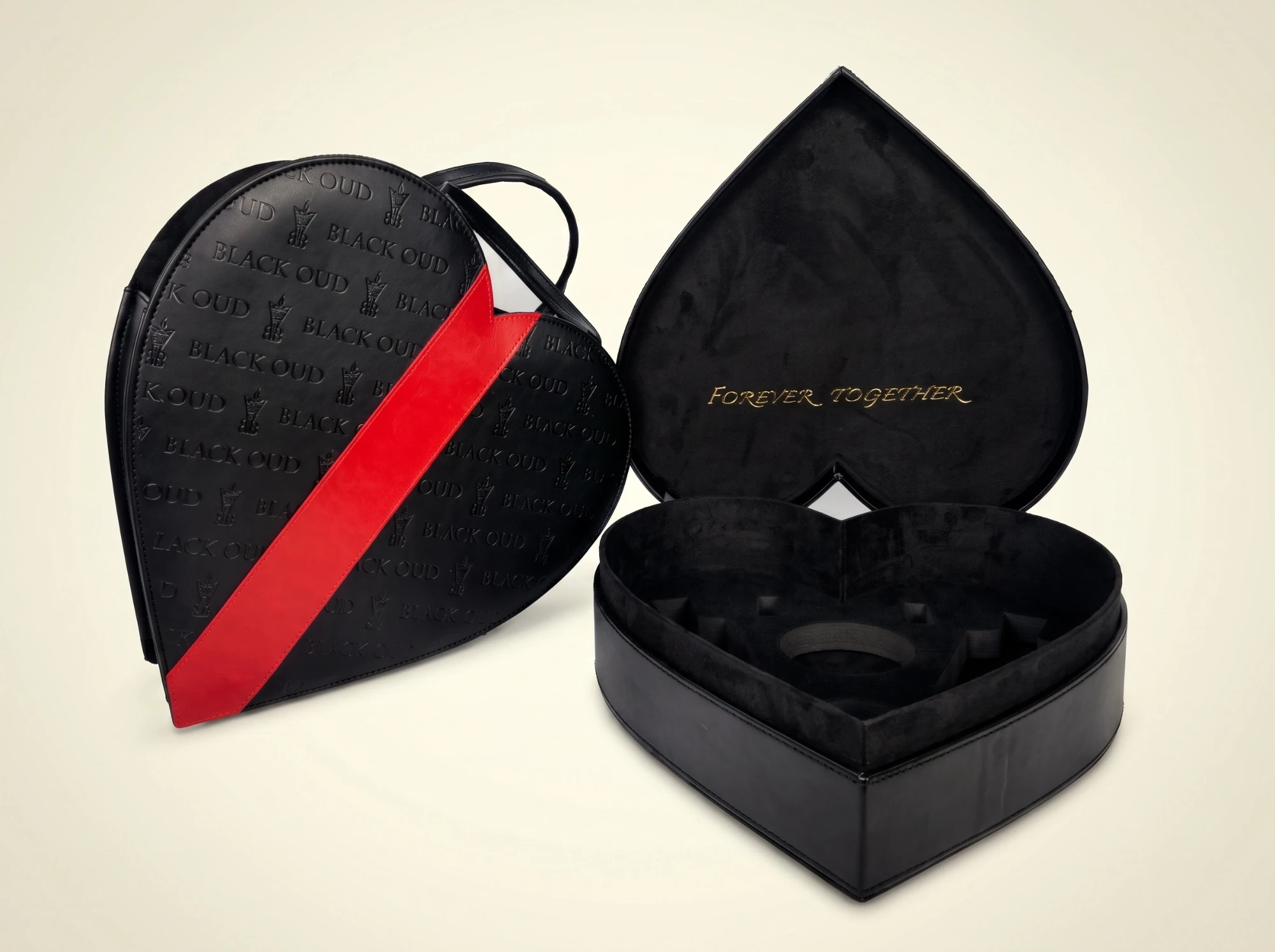 Black heart-shaped perfume box with red ribbon and fitted insert